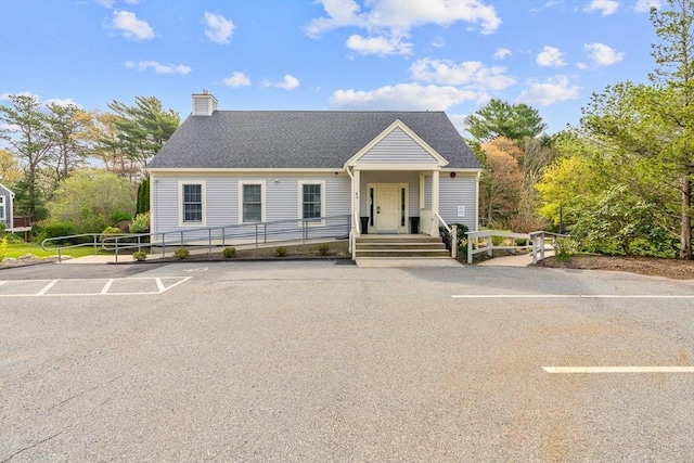47 Blue Spruce Way Unit 47, Mashpee, MA 02649 - view of front of home with uncovered parking, roof with shingles, and a chimney