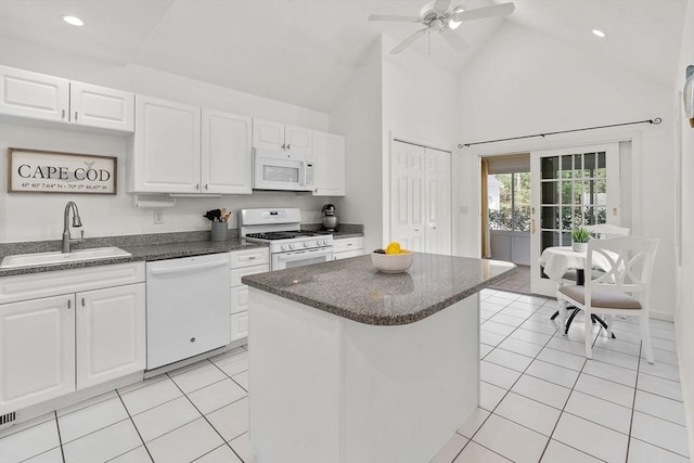 47 Blue Spruce Way Unit 47, Mashpee, MA 02649 - kitchen with light tile patterned floors, white appliances, a sink, white cabinetry, and high vaulted ceiling