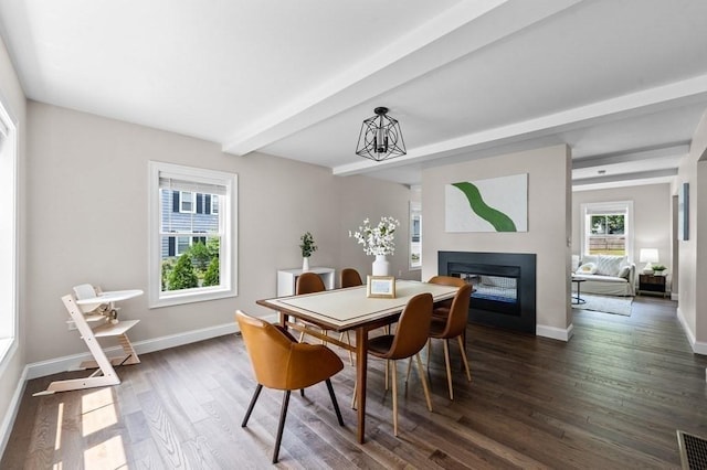 dining room with a chandelier, beamed ceiling, a healthy amount of sunlight, and dark hardwood / wood-style floors