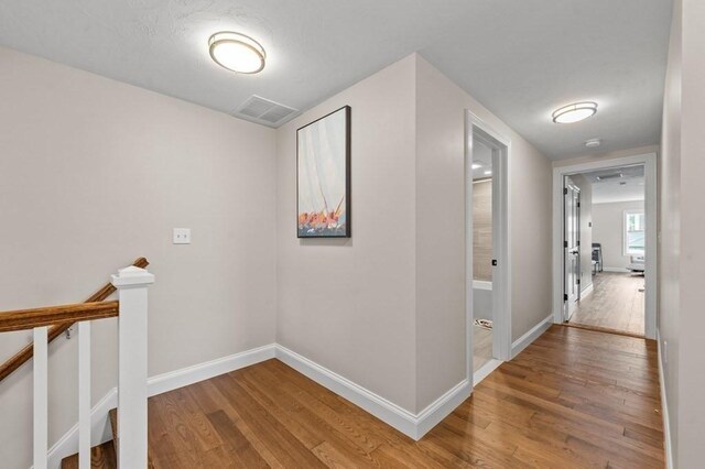 hallway with hardwood / wood-style floors