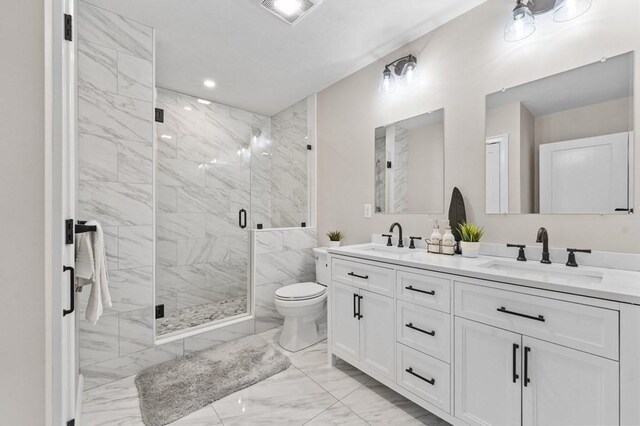 bathroom featuring vanity, toilet, and an enclosed shower