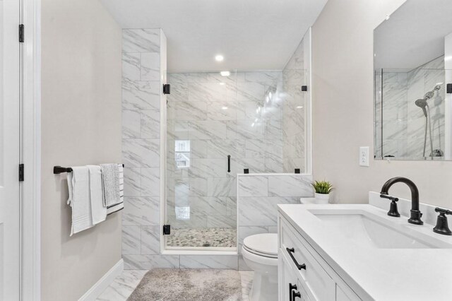 bathroom featuring vanity, toilet, and walk in shower