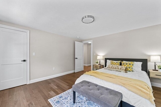 bedroom with dark hardwood / wood-style flooring