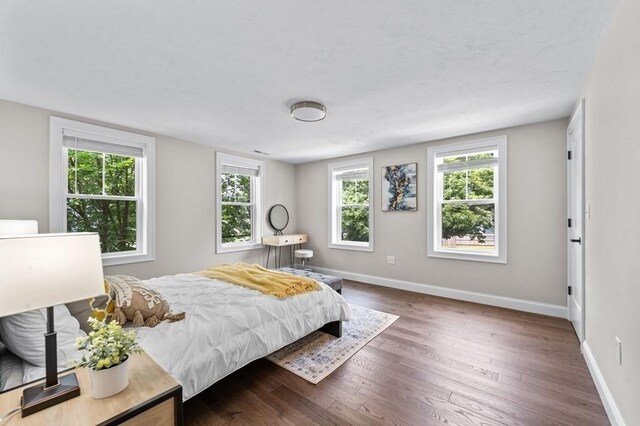 bedroom with dark wood-type flooring