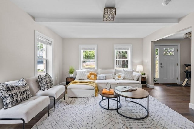 living room with beam ceiling and dark wood-type flooring