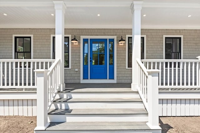 view of exterior entry with covered porch