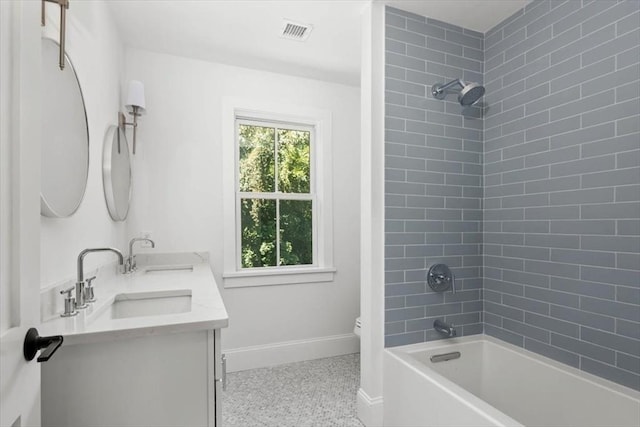 bathroom with toilet, visible vents, a sink, and baseboards