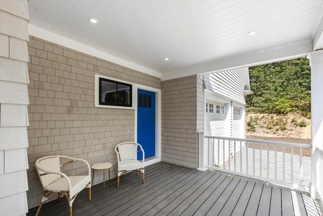 wooden deck featuring a garage