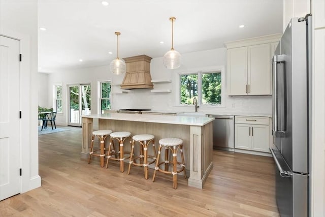 kitchen featuring light countertops, appliances with stainless steel finishes, backsplash, and a healthy amount of sunlight