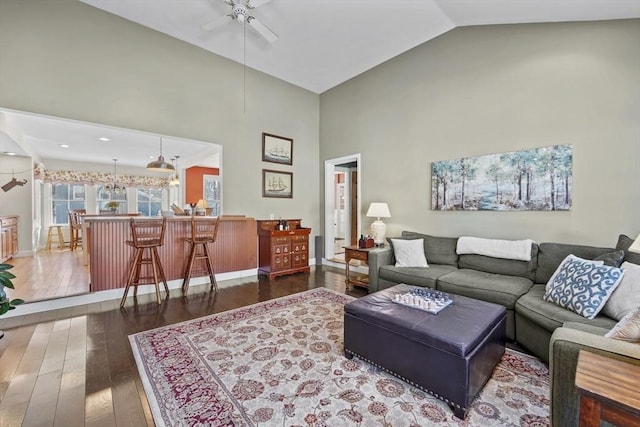 living room featuring ceiling fan, dark hardwood / wood-style flooring, and high vaulted ceiling