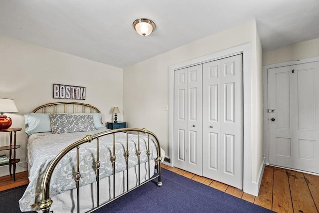 bedroom featuring hardwood / wood-style floors and a closet