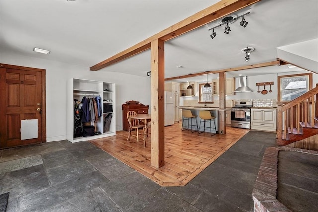 living room featuring sink and beamed ceiling