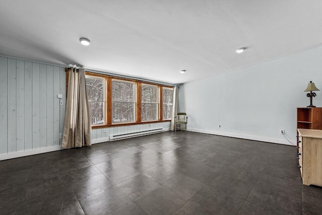 unfurnished living room featuring a baseboard heating unit