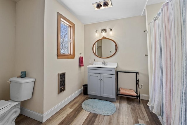 bathroom with vanity, hardwood / wood-style flooring, and toilet