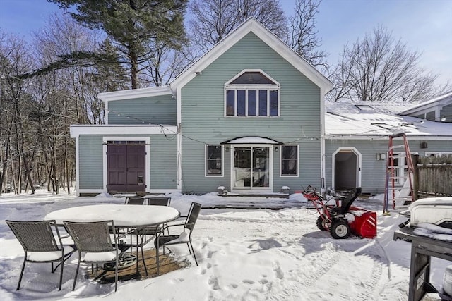 view of snow covered back of property