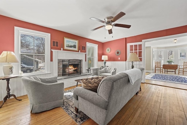 living room featuring hardwood / wood-style floors, plenty of natural light, and ceiling fan