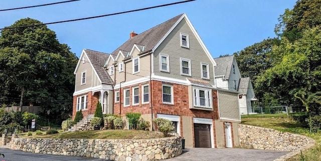 43 Brunswick Rd, Arlington, MA 02474 - shingle-style home with driveway, a chimney, a garage, brick siding, and fence