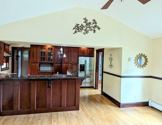 43 Brunswick Rd, Arlington, MA 02474 - kitchen featuring a baseboard radiator, stainless steel fridge with ice dispenser, a peninsula, light wood-type flooring, and a kitchen bar