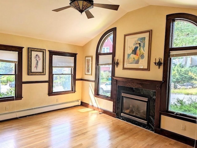 43 Brunswick Rd, Arlington, MA 02474 - unfurnished living room with plenty of natural light, a fireplace, vaulted ceiling, wood finished floors, and a baseboard radiator