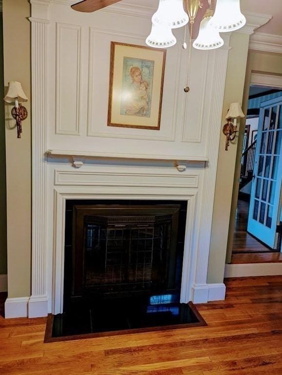 43 Brunswick Rd, Arlington, MA 02474 - room details featuring a chandelier, baseboards, a fireplace with flush hearth, and wood finished floors