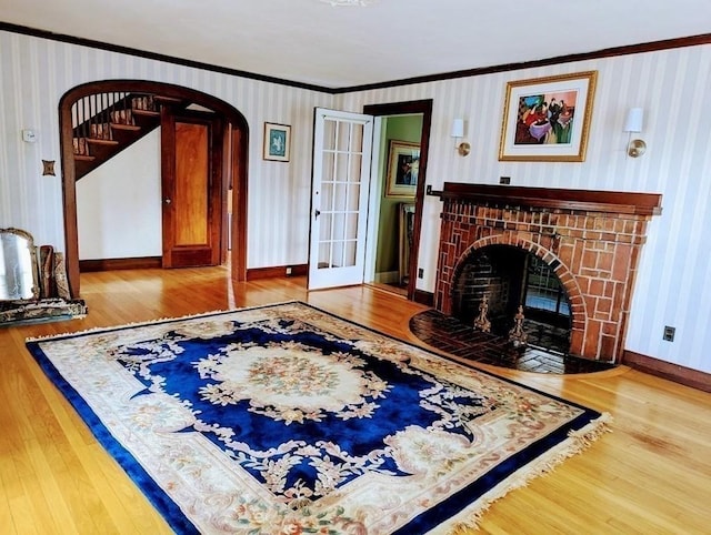 43 Brunswick Rd, Arlington, MA 02474 - living room featuring crown molding, arched walkways, baseboards, and wood finished floors