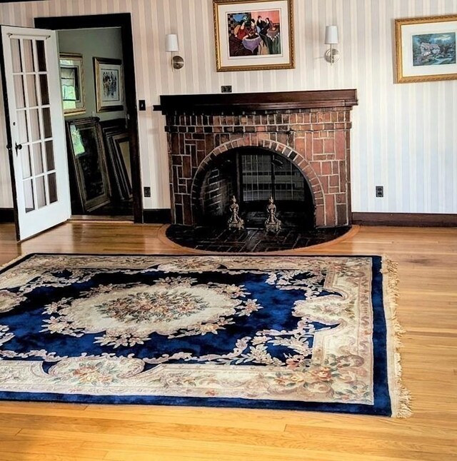 43 Brunswick Rd, Arlington, MA 02474 - living room featuring baseboards, wallpapered walls, wood finished floors, and a fireplace