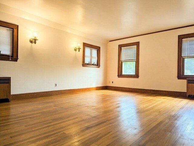43 Brunswick Rd, Arlington, MA 02474 - unfurnished room featuring wood finished floors, baseboards, and radiator heating unit