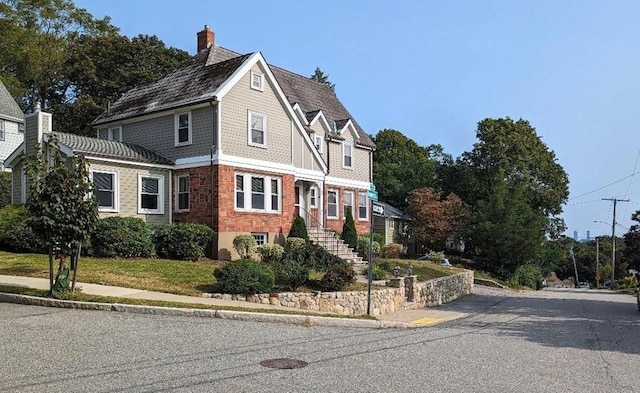 43 Brunswick Rd, Arlington, MA 02474 - view of front facade with brick siding and a chimney
