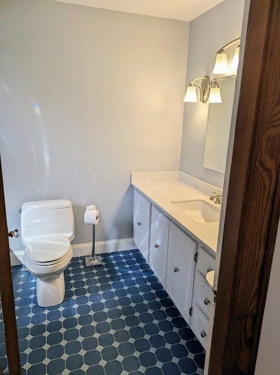 43 Brunswick Rd, Arlington, MA 02474 - half bath with tile patterned floors, baseboards, vanity, and toilet