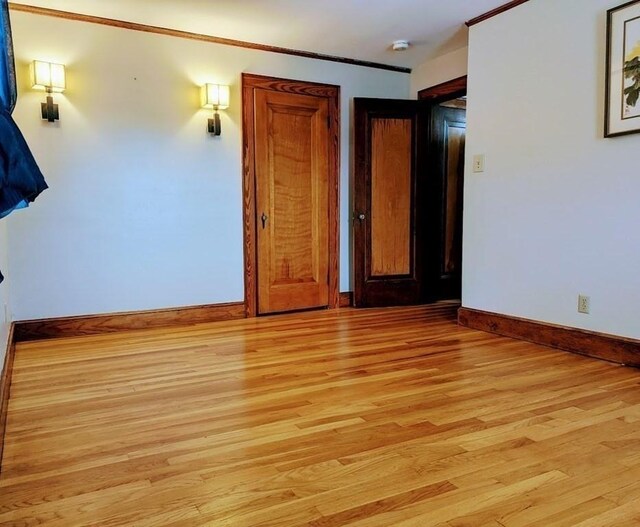 43 Brunswick Rd, Arlington, MA 02474 - unfurnished room with light wood-type flooring, baseboards, and crown molding