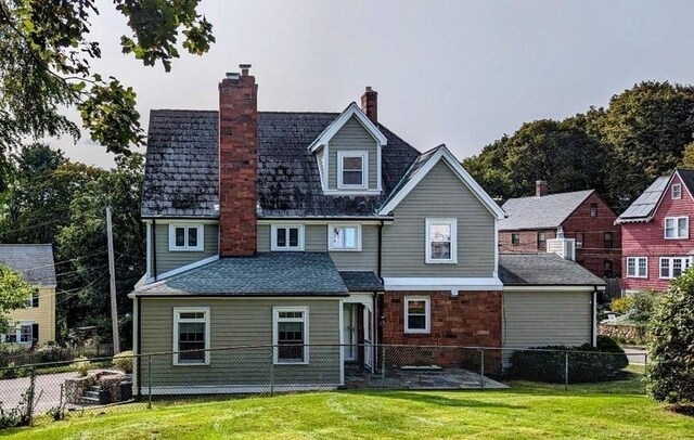 43 Brunswick Rd, Arlington, MA 02474 - rear view of house with a fenced backyard, a patio area, a yard, and a chimney
