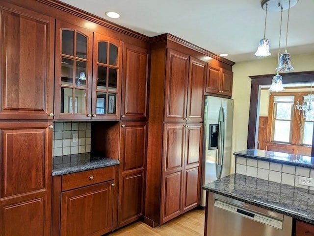 43 Brunswick Rd, Arlington, MA 02474 - kitchen with pendant lighting, tasteful backsplash, glass insert cabinets, dark stone counters, and stainless steel appliances