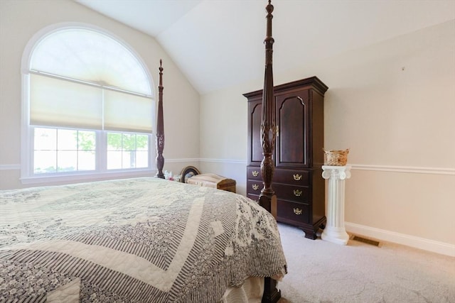 bedroom with lofted ceiling, light carpet, and baseboards