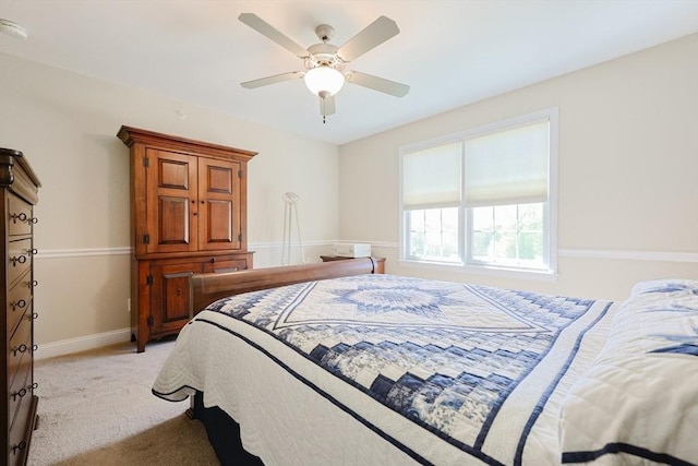 bedroom with light carpet, baseboards, and ceiling fan