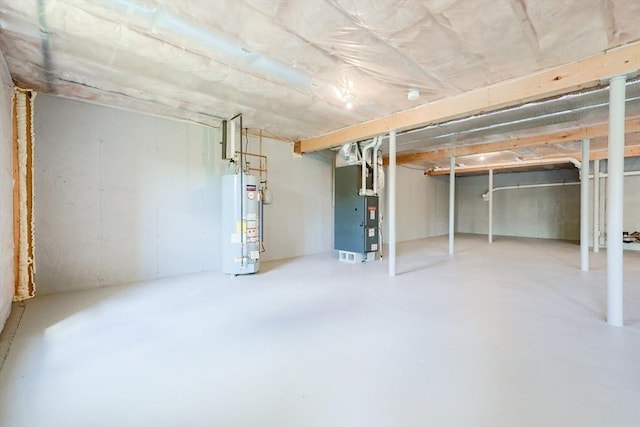 unfinished basement with gas water heater and heating unit
