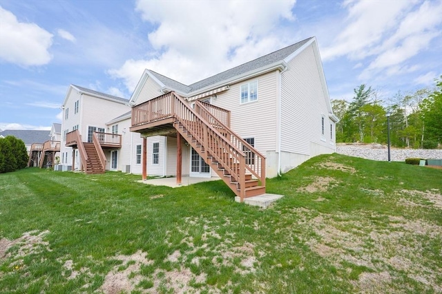 rear view of property with stairway, a wooden deck, a yard, and a patio area