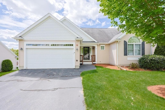 ranch-style home featuring driveway, a front lawn, and an attached garage