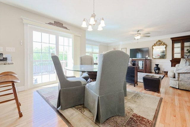 dining area with a chandelier, light wood finished floors, and ceiling fan