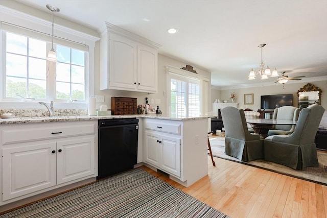 kitchen featuring black dishwasher, open floor plan, a chandelier, a peninsula, and light wood finished floors