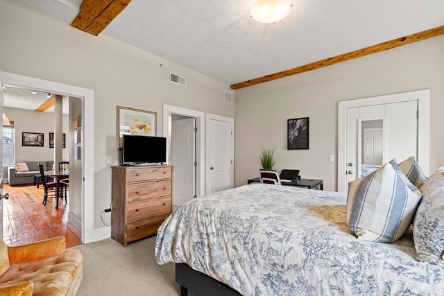 carpeted bedroom with baseboards and visible vents