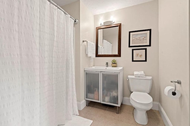 bathroom with vanity, a shower with curtain, baseboards, tile patterned flooring, and toilet