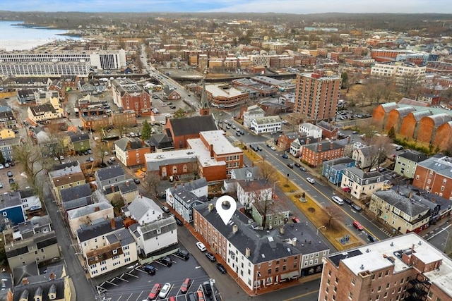 drone / aerial view featuring a view of city and a water view