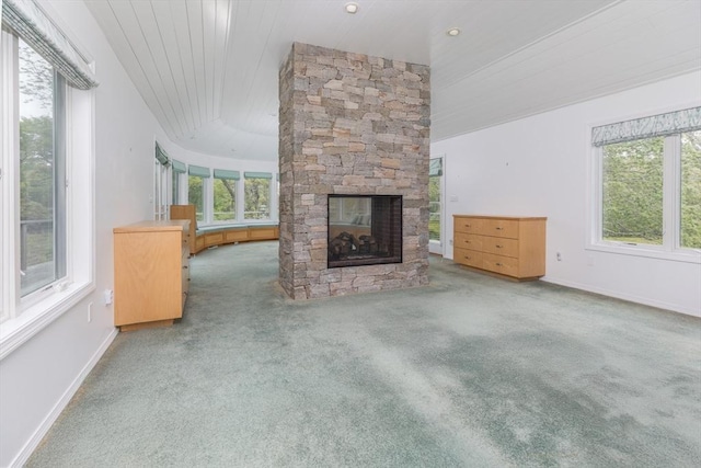 9 Beetlebung Grove Way, Chilmark, MA 02535 - unfurnished living room featuring healthy amount of natural light, carpet floors, a stone fireplace, baseboards, and wood ceiling