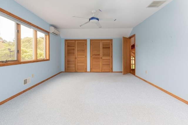 9 Beetlebung Grove Way, Chilmark, MA 02535 - unfurnished bedroom with multiple closets, a wall mounted AC, baseboards, and light carpet