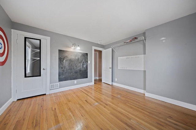 spare room with light hardwood / wood-style flooring