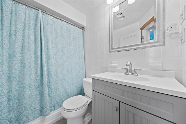 bathroom with vanity, a shower with curtain, decorative backsplash, toilet, and tile walls