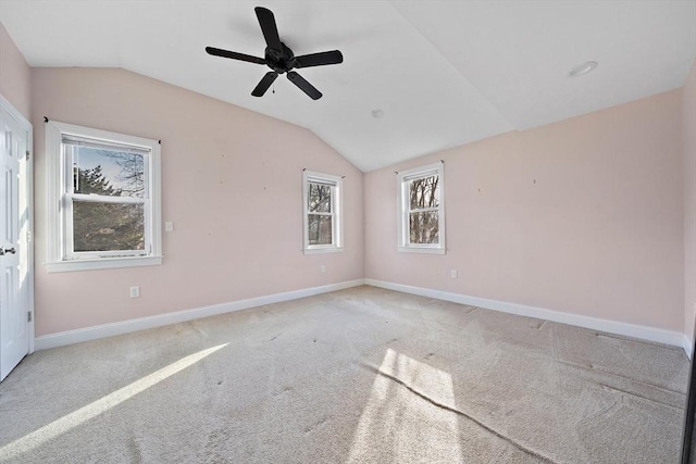 carpeted empty room featuring ceiling fan and lofted ceiling