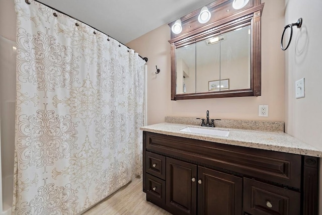 bathroom with wood-type flooring and vanity