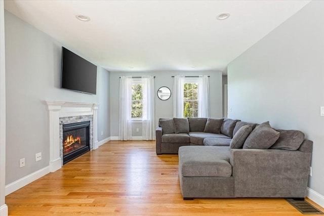 0 Thompson St, Middleboro, MA 02346 - living room with light wood-style floors, a stone fireplace, and recessed lighting