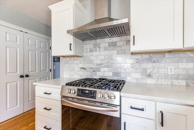 0 Thompson St, Middleboro, MA 02346 - kitchen featuring wall chimney range hood, stainless steel range with gas cooktop, white cabinets, light wood-type flooring, and backsplash